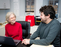 Jonas providing tech help to Ellen Harrison